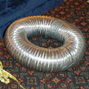 Loop of dryer vent ready for upholstering into a hat